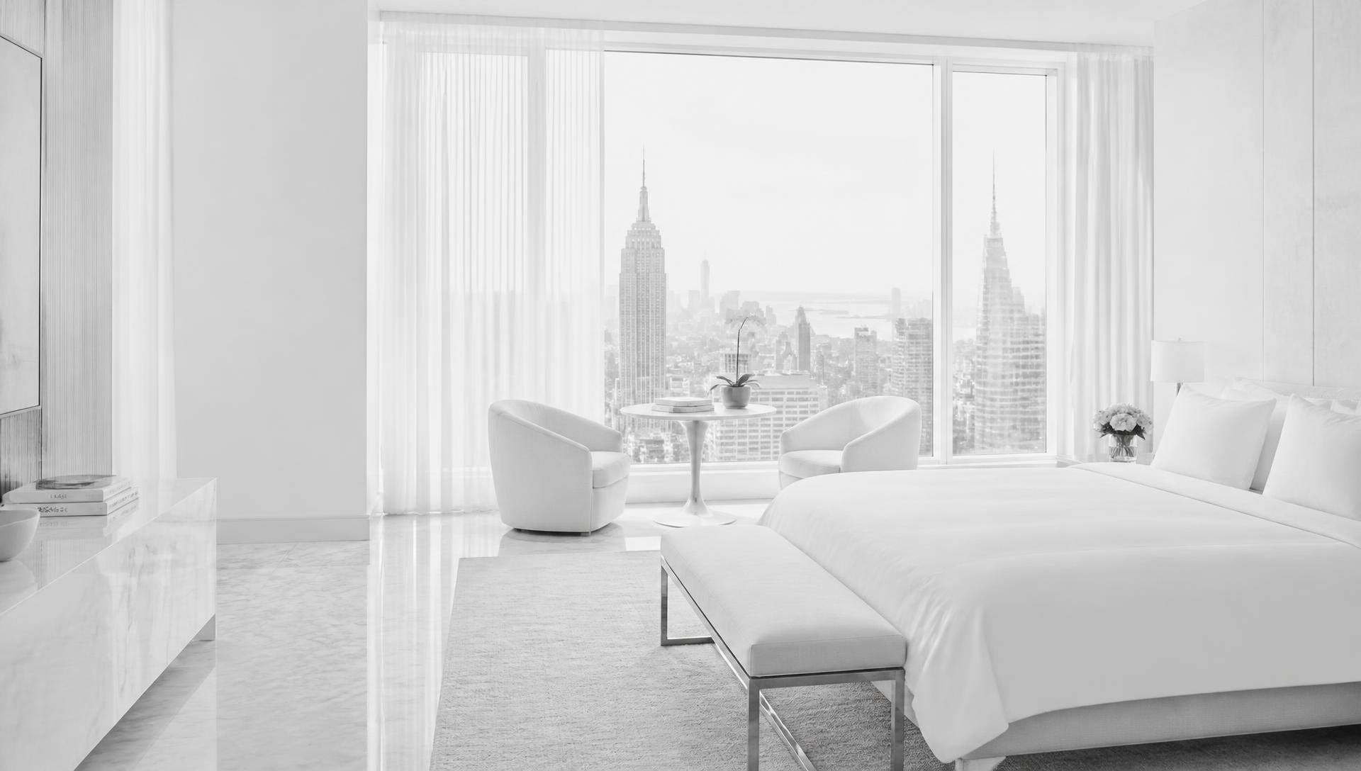 Bright luxury hotel suite with the Manhattan skyline in daylight
